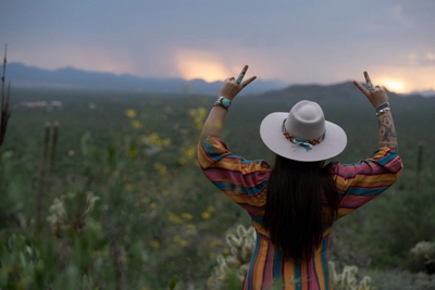 Ellanora DellErba signing peace to the sunset.